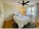 Cozy bedroom features hardwood floors, a ceiling fan, a window, and warm, neutral-colored walls at 4934 S Flower Way, Littleton, CO 80123