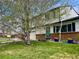 Charming two-story home with green lawn, brick accents, attached garage, and beautiful trees at 4934 S Flower Way, Littleton, CO 80123