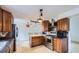 Well-lit kitchen with stainless steel appliances, wood cabinetry and a wooden island at 4934 S Flower Way, Littleton, CO 80123
