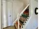 Unique staircase design with decorative black and white book titles at 4934 S Flower Way, Littleton, CO 80123