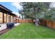 Spacious backyard features lush lawn, privacy fence, and a charming pergola-covered patio perfect for outdoor relaxation at 1157 Jersey St, Denver, CO 80220