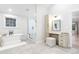 Bright bathroom features a soaking tub, a glass shower, and a vanity area at 1157 Jersey St, Denver, CO 80220