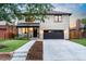Beautiful two-story stone house with a well-manicured lawn and a dark gray garage door at 1157 Jersey St, Denver, CO 80220