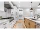Bright, open kitchen with stainless steel range hood, marble countertops, and custom cabinetry at 1157 Jersey St, Denver, CO 80220