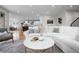 Open-concept living room showcases neutral décor, hardwood floors and flows into the kitchen at 1157 Jersey St, Denver, CO 80220