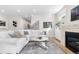 Spacious living room boasts a fireplace, large windows, hardwood floors, and comfortable seating at 1157 Jersey St, Denver, CO 80220