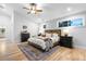 Spacious main bedroom featuring a wooden bed frame, neutral decor, and a ceiling fan at 1157 Jersey St, Denver, CO 80220