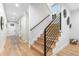 Entryway features hardwood floors, modern railing staircase, and ample natural light at 1157 Jersey St, Denver, CO 80220