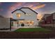 A two-story white home with an outdoor patio with a pergola and small grass area at Reunion Freunion F Mobile St, Commerce City, CO 80022