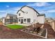 Exterior view of a home featuring a pergola with lounge seating, fire pit, and a well-maintained lawn at Reunion Freunion F Mobile St, Commerce City, CO 80022