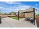 Spacious backyard with a modern pergola, patio, artificial turf, and a cozy fire pit area at Reunion Freunion F Mobile St, Commerce City, CO 80022