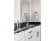 Bathroom with a white cabinet, granite countertop, and gold faucet at Reunion Freunion F Mobile St, Commerce City, CO 80022