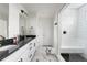 Bathroom featuring a double sink vanity, a glass-enclosed shower, and marble flooring, creating a luxurious feel at Reunion Freunion F Mobile St, Commerce City, CO 80022