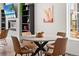 Dining area with modern table, chairs, chandelier, and built-in shelving with decorative items at Reunion Freunion F Mobile St, Commerce City, CO 80022