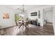 Cozy dining area with hardwood floors, modern light fixture, and large window at Reunion Freunion F Mobile St, Commerce City, CO 80022