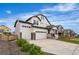 Well-maintained two-story home featuring a three-car garage and manicured landscaping at Reunion Freunion F Mobile St, Commerce City, CO 80022