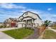 Charming two-story home with landscaped yard, covered front porch, and a two-car garage at Reunion Freunion F Mobile St, Commerce City, CO 80022