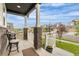 Charming front porch features a table, chairs, and views of the neighborhood at Reunion Freunion F Mobile St, Commerce City, CO 80022