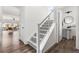 Modern hallway featuring a staircase with metal railings and a view into the living room at Reunion Freunion F Mobile St, Commerce City, CO 80022