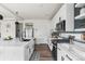Modern kitchen with white cabinets, stainless steel appliances, and stylish fixtures at Reunion Freunion F Mobile St, Commerce City, CO 80022