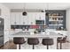 Bright kitchen with a large island, seating, and a stylish, dark backsplash at Reunion Freunion F Mobile St, Commerce City, CO 80022