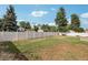 Spacious backyard with a well-maintained lawn and tall privacy fence at 14791 E Security Pl, Aurora, CO 80011
