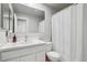 Bathroom features a single vanity, white walls, and shower-tub combo at 14791 E Security Pl, Aurora, CO 80011
