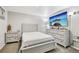 This bedroom features bright walls, a bed, and a dresser with a large television above it at 14791 E Security Pl, Aurora, CO 80011