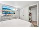 A well lit bedroom is shown with a closet, dresser with television, and neutral walls at 14791 E Security Pl, Aurora, CO 80011