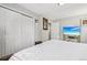 Cozy bedroom with closet, white walls, and television at 14791 E Security Pl, Aurora, CO 80011
