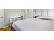 Spacious bedroom with two beds, gray walls, and hardwood floors at 14791 E Security Pl, Aurora, CO 80011