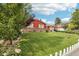 Single-story home with a spacious green front lawn and a cozy, well-manicured landscape at 14791 E Security Pl, Aurora, CO 80011
