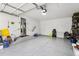 Large garage with epoxy flooring, storage, and access to the main residence at 14791 E Security Pl, Aurora, CO 80011
