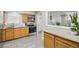 Updated kitchen with granite countertops, stainless appliances, wood cabinets, and tile floor at 14791 E Security Pl, Aurora, CO 80011