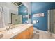 Bathroom with double sinks, large mirrors, and glass enclosed shower at 1720 Wazee St # 3B, Denver, CO 80202