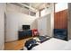 Bedroom with hardwood floors, exposed ductwork, brick accent, and closet at 1720 Wazee St # 3B, Denver, CO 80202
