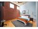 Serene bedroom with exposed brick wall features ample natural light and hardwood floors at 1720 Wazee St # 3B, Denver, CO 80202