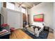 Loft style bedroom featuring exposed ductwork, hardwood floors, and brick accent wall at 1720 Wazee St # 3B, Denver, CO 80202