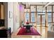 Dining room featuring hardwood floors, large windows, modern lighting, and a stylish dining set at 1720 Wazee St # 3B, Denver, CO 80202