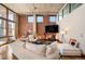 Bright living room featuring exposed brick, hardwood floors, large windows, and comfortable seating at 1720 Wazee St # 3B, Denver, CO 80202