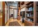 Open living space with hardwood floors, built in shelving, and a mounted television at 1720 Wazee St # 3B, Denver, CO 80202
