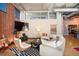 Comfortable living room featuring hardwood floors, large windows, and cozy seating at 1720 Wazee St # 3B, Denver, CO 80202