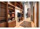 Living room featuring hardwood floors, built-in bookshelves, and exposed ductwork at 1720 Wazee St # 3B, Denver, CO 80202