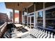 Open-air patio with large windows and awning, offering a comfortable seating area and dining space at 1720 Wazee St # 3B, Denver, CO 80202