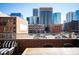 Spacious patio with scenic cityscape views, wooden table, and modern outdoor furniture at 1720 Wazee St # 3B, Denver, CO 80202