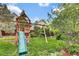 Backyard featuring a wooden playset, swing set, and green grass, ideal for Gathering fun at 10882 Bullock Ct, Parker, CO 80134