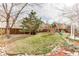 Large backyard featuring a wooden playset, green grass, decorative rocks, and a privacy fence at 10882 Bullock Ct, Parker, CO 80134