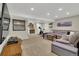 Expansive finished basement with a lounge, exercise area, and bar at 10882 Bullock Ct, Parker, CO 80134