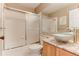 Bright bathroom features a tub with glass doors, vanity with granite countertop, and vessel sink at 10882 Bullock Ct, Parker, CO 80134