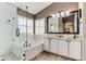 Bright bathroom with tile floors, standalone tub, tiled shower, white cabinets, and granite countertops at 10882 Bullock Ct, Parker, CO 80134